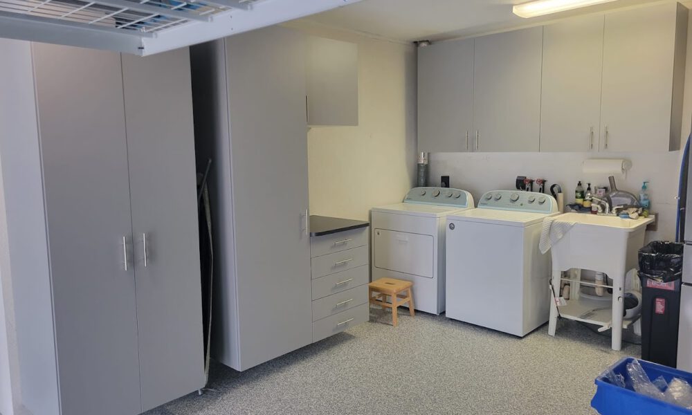 Laundry area with polyaspartic flooring and garage cabinets